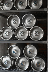 Metal beer kegs lie in a row