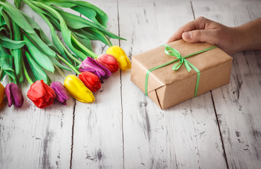 Tulips of different color on wooden background