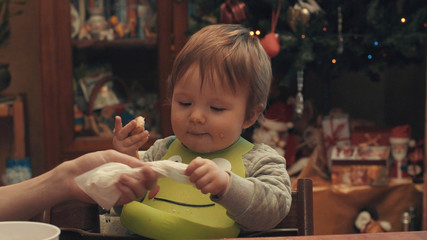 Someone taking doily from the baby