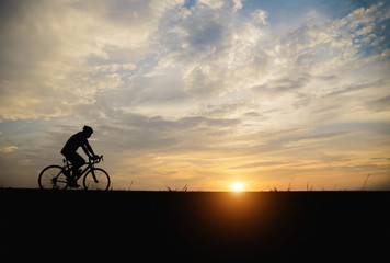 Silhouette of a man  biker in the sunset