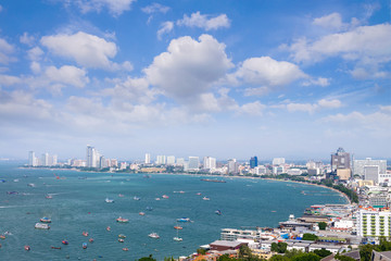 Fototapeta na wymiar Pattaya cityscape and pattaya sea bay in top view with blue sky and cloud is city is famous tourist Attractions about sea sport and night life entertainment, Chon Buri, Thailand