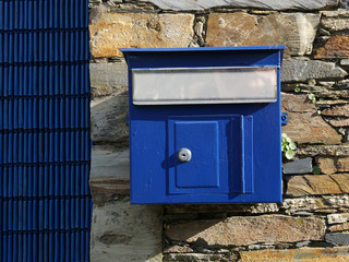 Old blue mailbox hanging
