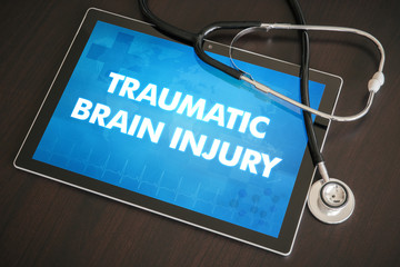 Traumatic brain injury (neurological disorder) diagnosis medical concept on tablet screen with...