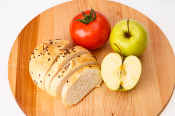 white bread with beans, tomato, Apple on a wooden tray