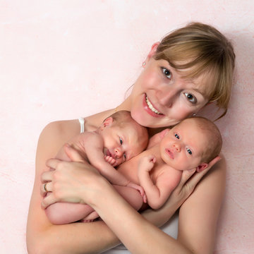 Happy Mother With Newborn Twin Babies