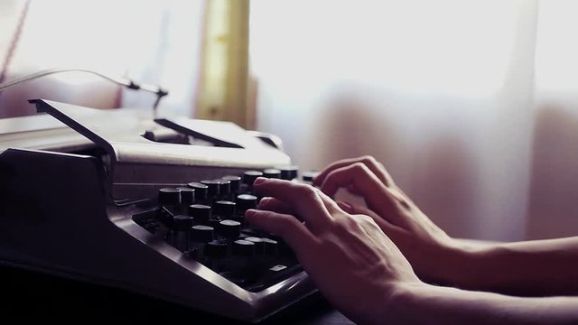 A young girl is typing on an old typewriter. Slow Motion. 1920x1080. HD