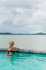Woman relaxing in pool in resort