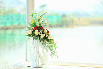 The Flowers in the vase and near the windows.