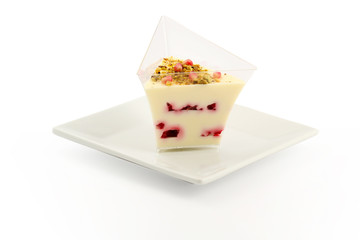 Vanilla cream with raspberries and pistachios 