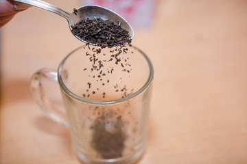 Fill tea in a bowl. Tea preparation.