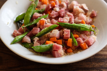 The second dish - meat and rice with vegetables (pods of green peas and other)