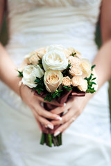 Obraz na płótnie Canvas Beauty wedding bouquet in bride's hands, close - up