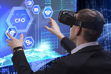 Business, Technology, Internet and network concept. Young businessman working on a virtual screen of the future and sees the inscription: CFO