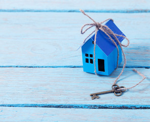 house paper with key on wooden background