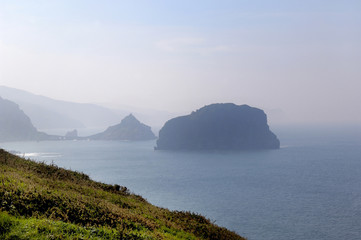 Landscape of Machichaco cape in the background the church of San Juan de Gaztelugatxe, Bermeo, Vizcaya, Basque Country, Spain