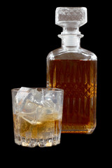 Glass and bottle whiskey on wooden table