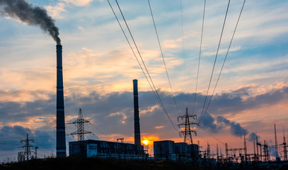 Thermoelectric station generating smokes at the sunset