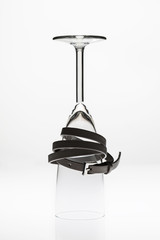 Empty glass on white background with black belt Still Life