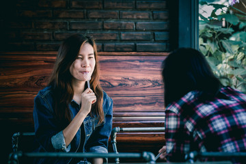 Asia teenage hipster in happiness with friend in cafe.