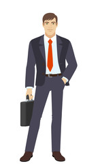 Businessman with briefcase standing with hand in pocket