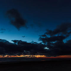 Obraz premium Dark blue cloudy sky over the Baltic sea at night
