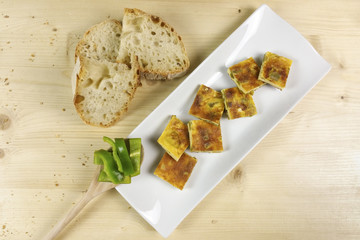 Omelette with peppers on wood background - top view