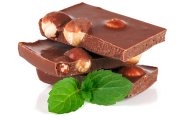 Chocolate with hazelnut and mint leaf isolated on white background
