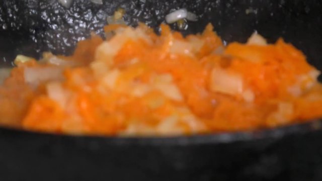 Chopped onions and carrots fried in vegetable oil in the pan