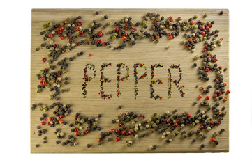 Inscription of peppers on a cutting board, made with pepper, in a frame of pepper.