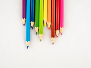 Brightly colored pencils on a white background