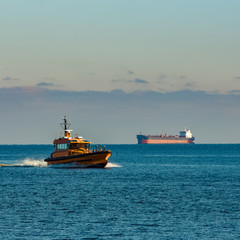 Yellow pilot ship moving at speed from the Baltic sea