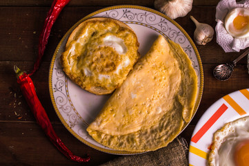 Different cooking eggs on a wooden background
