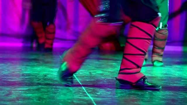 Close up of male legs of dancers on dancing floor of stage. Real time full hd video footage.