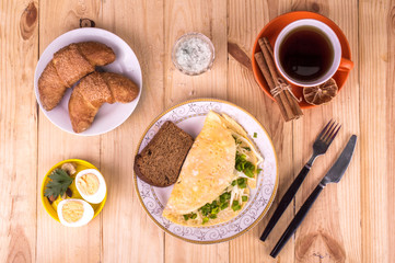 Omelette on a wooden background. Breakfast concept.