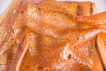 Macro detail of folded piece of cannabis oil concentrate aka shatter