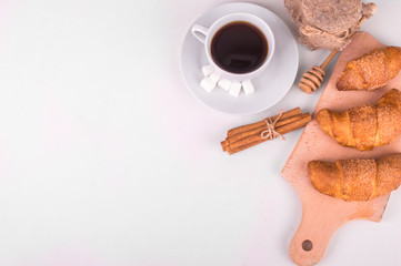 Coffee and croissant on a white background. Breakfast.