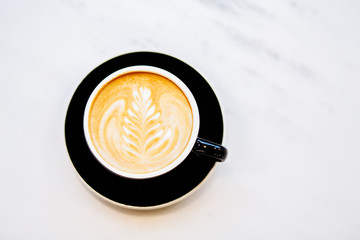 Top view of black cup of cappuccino