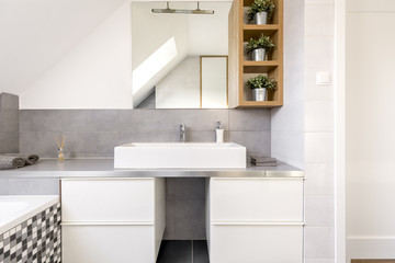 Fototapeta na wymiar Bathroom with white cabinets