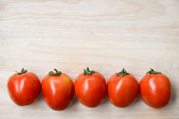 Tomatoes on wooden table background