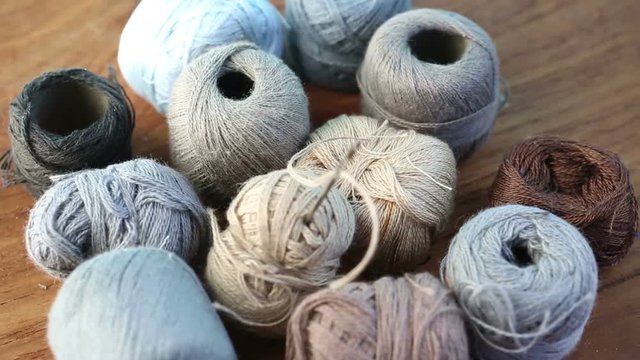 balls of yarn on rotating wooden board
