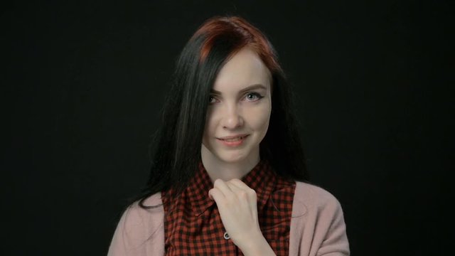 Young woman unbuttoning buttons