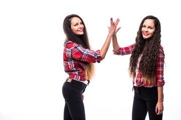 Fototapeta premium happy teen sisters giving five on white background