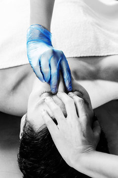 Physiotheraphist doing a sinus massage, theraphy in silhouette studio on white background