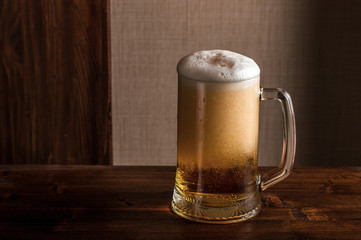 glass of beer on a wooden table top
