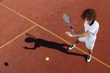 Foto op Plexiglas tennis player with racket during a match game © amedeoemaja