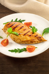 Grilled chicken fillet with cherry tomatoes and salad leaves