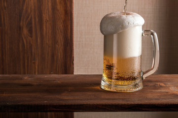 started a beer in a glass on a wooden table top