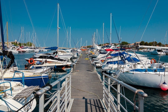 pier with moored boats in the port
