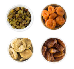 Collage of different dried fruits. Raisins, dates, dried apricots, figs isolated on white background. Top view.