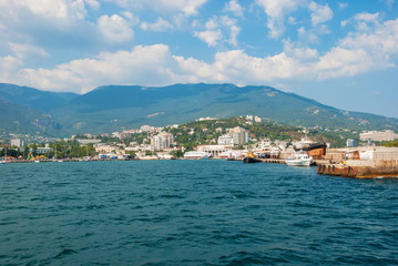 Fototapeta premium View of the embankment of Yalta and the pier from the Black Sea